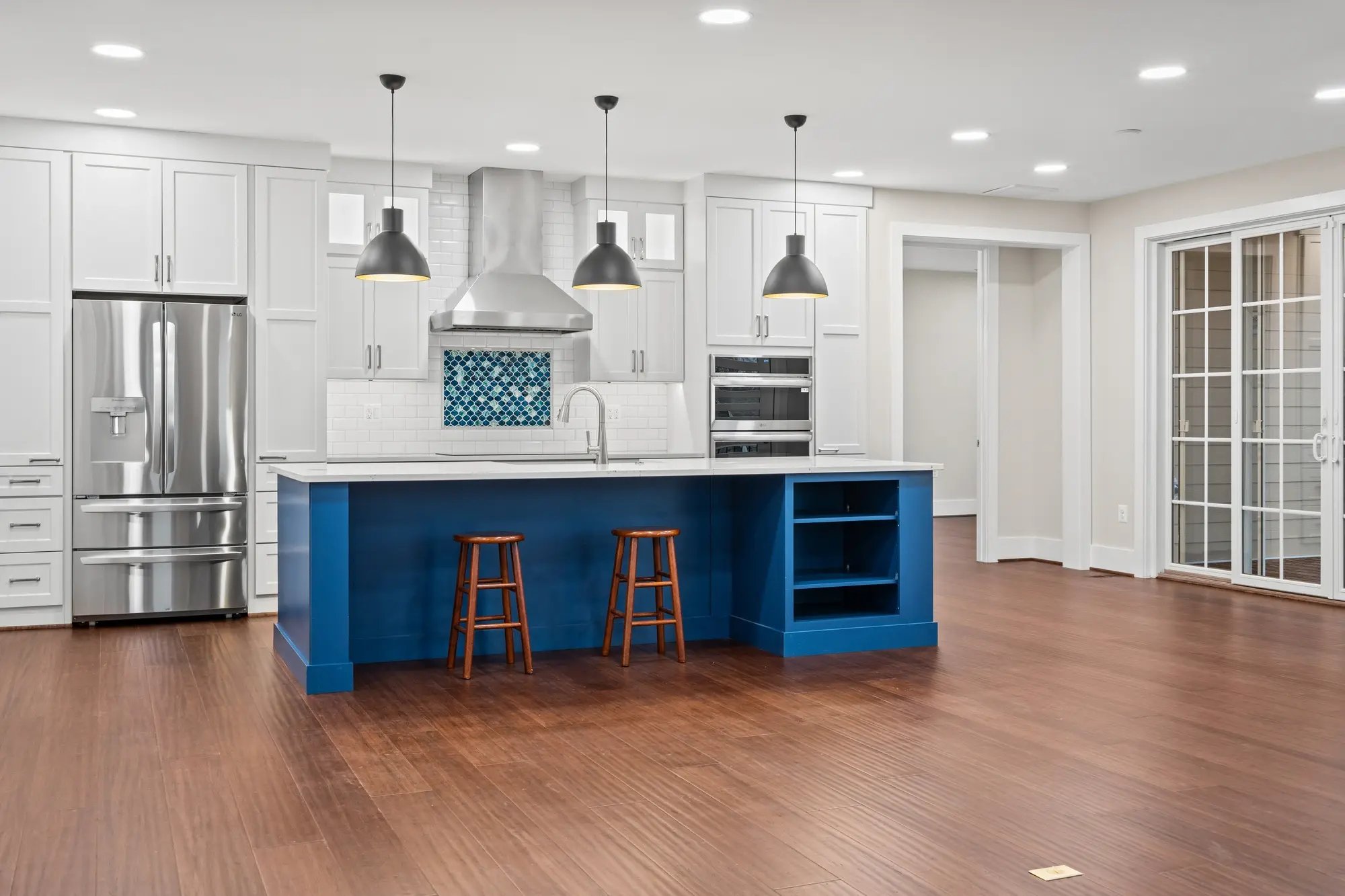Modern kitchen with blue island in Falls Church renovation, photographed by Umedia
